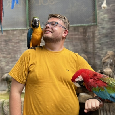 Keenan Patterson with two macaws